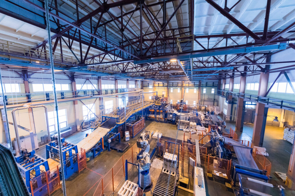 Fiberglass production industry equipment at manufacture background