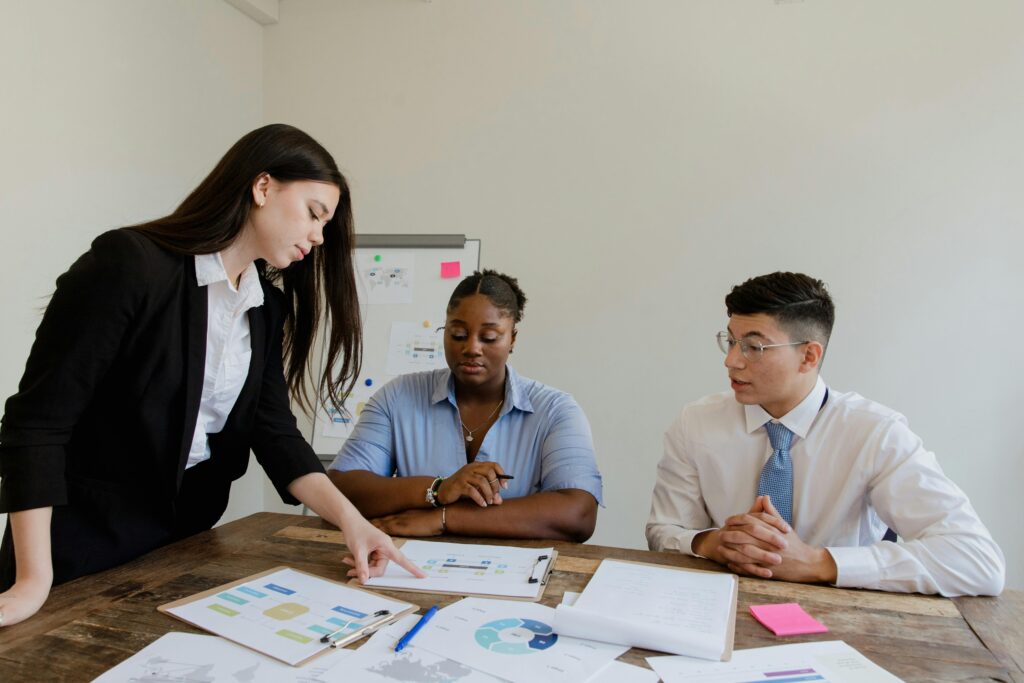 Diverse group of professionals engaged in a team meeting discussing business strategies.